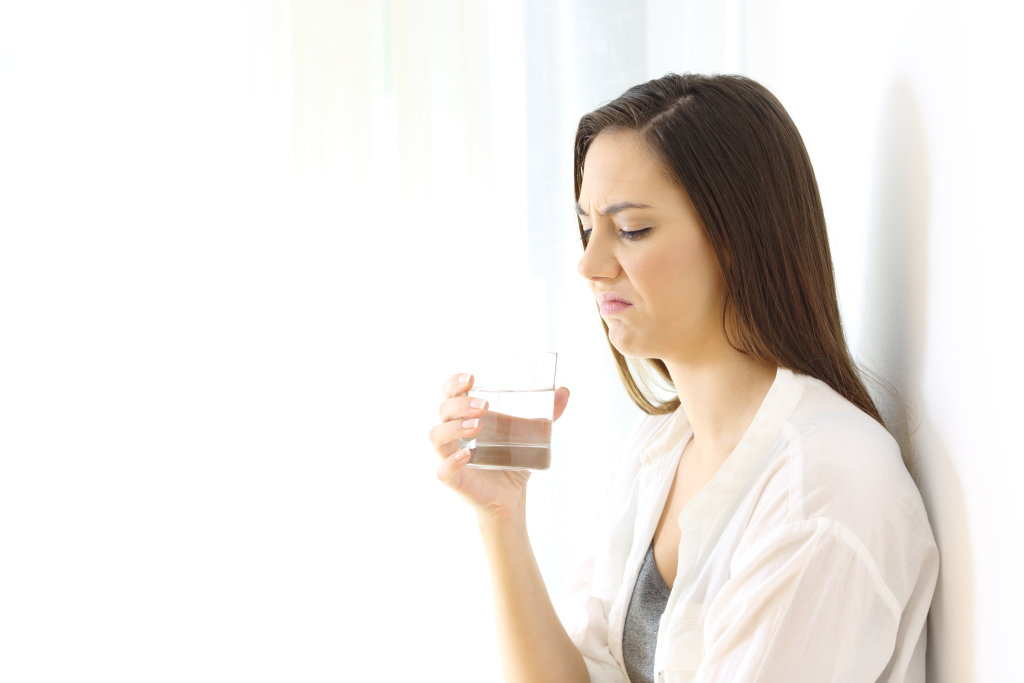 woman disgusted with water smell and taste